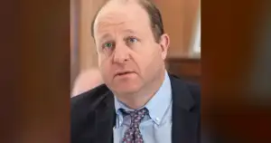 Polis promised $800 home insurance savings; his bill added a fee.